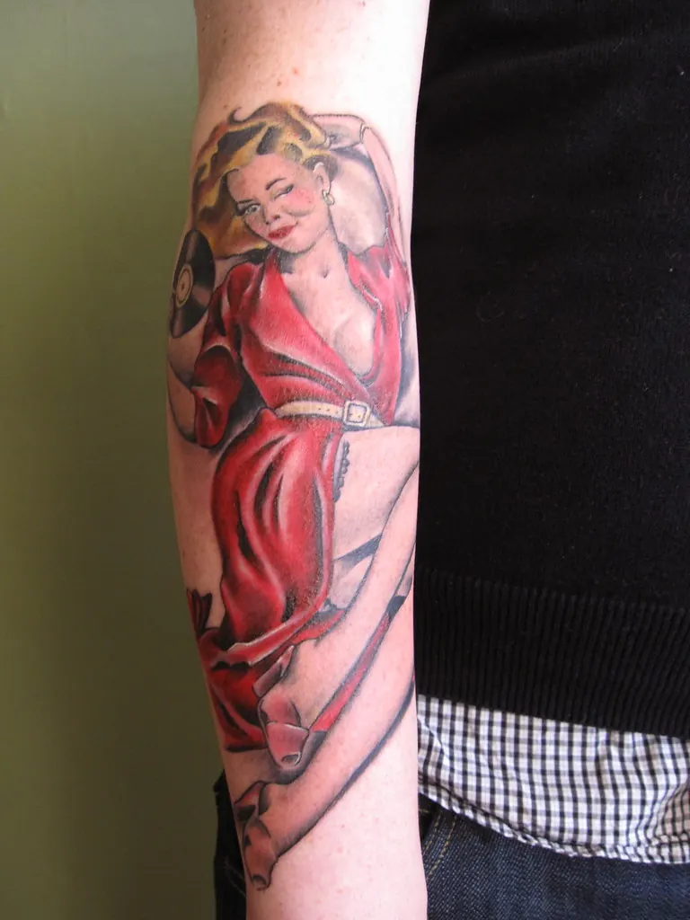 Pin-up tattoo on a forearm