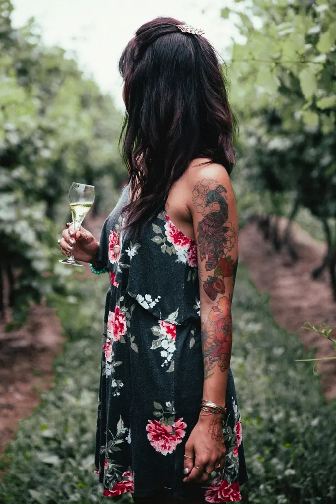 Woman with tattooed arms in a floral dress